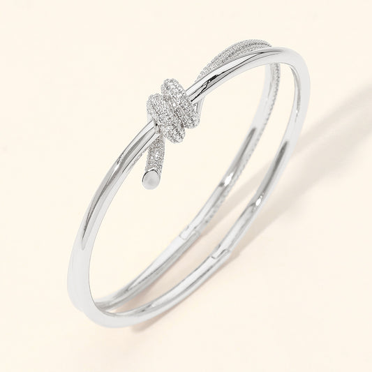 CZ Pave Knot Accent Hinged Bangle Bracelet in Rhodium