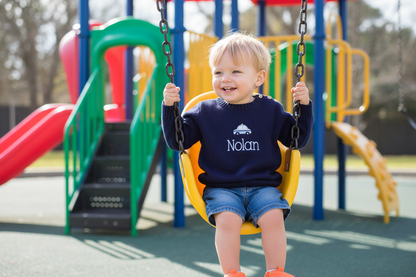 Child on a swing set with a playground in the background